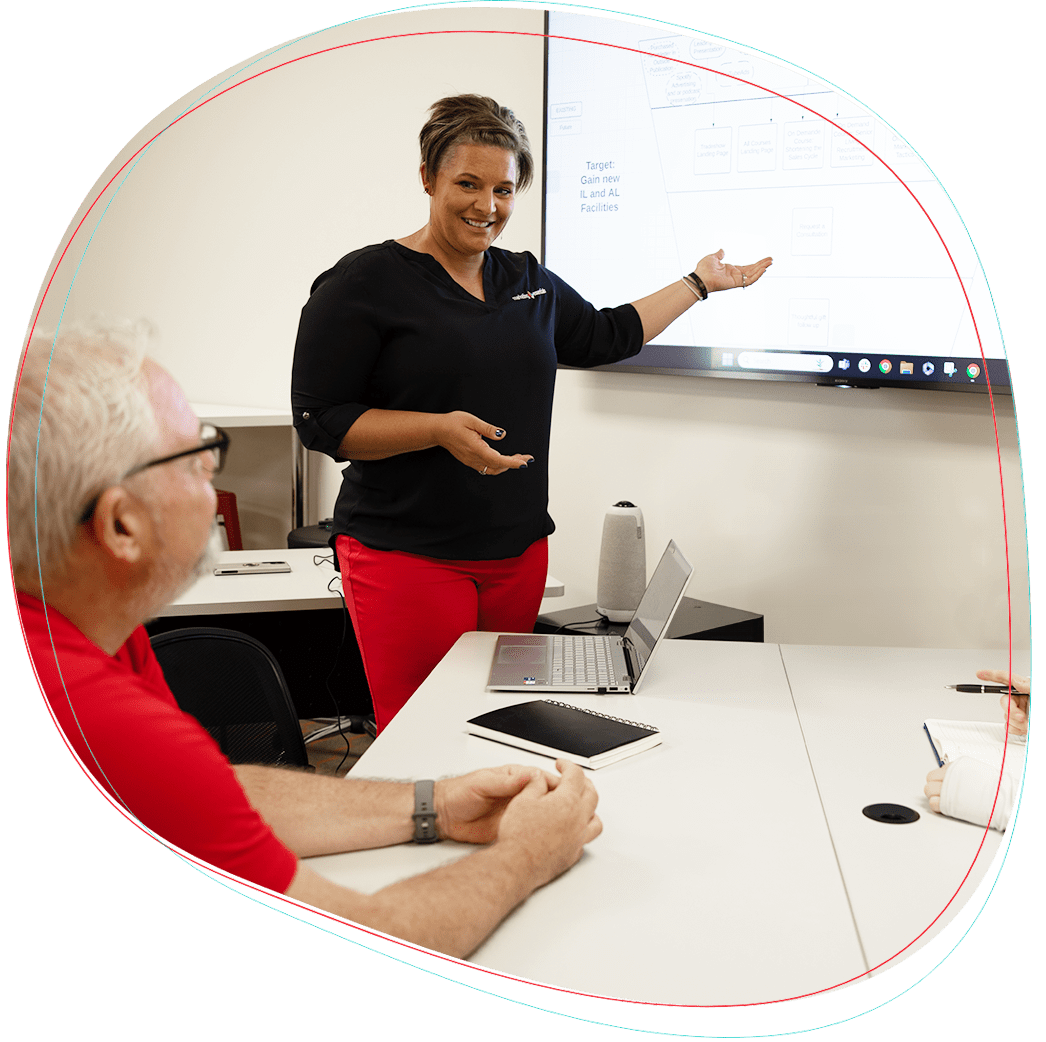 A woman talking by a white board