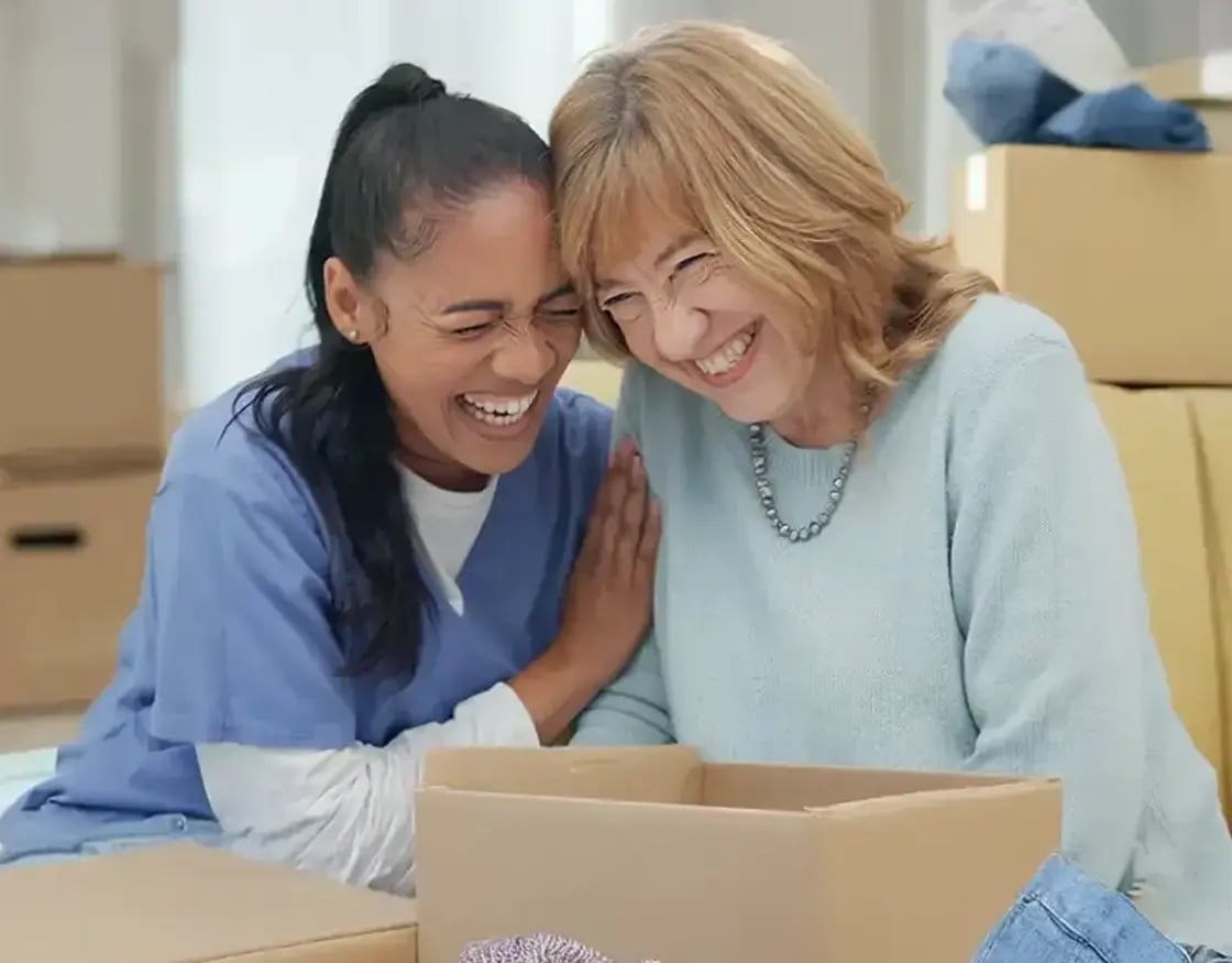 Senior lady laughing with nurse