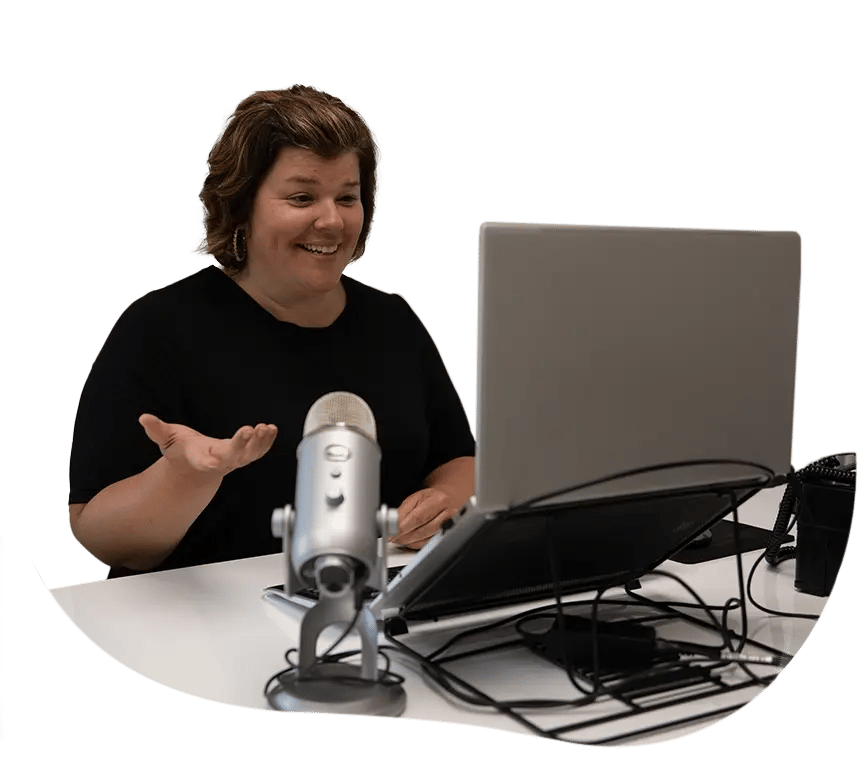 Team member talking on microphone at computer