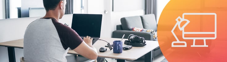 Person working on the computer at a desk in their house