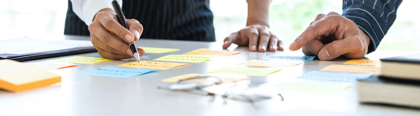 People putting together a content strategy using sticky notes