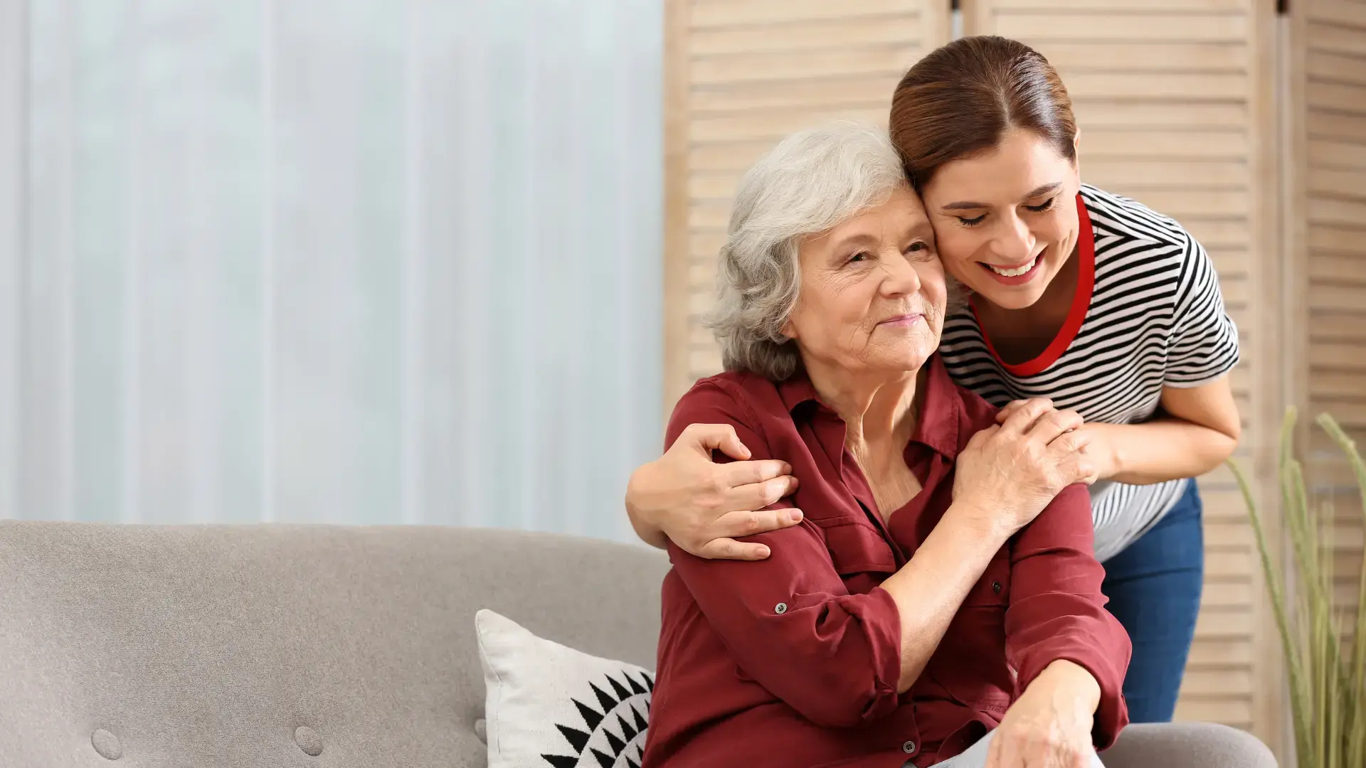 Elderly woman with female caregiver